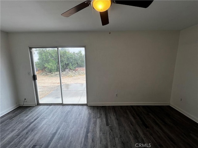 spare room featuring wood finished floors, a ceiling fan, and baseboards