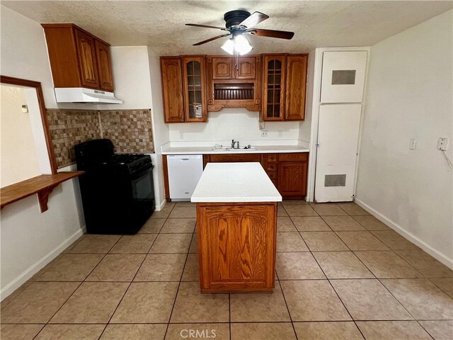 kitchen featuring black gas stove, white dishwasher, under cabinet range hood, ceiling fan, and brown cabinets