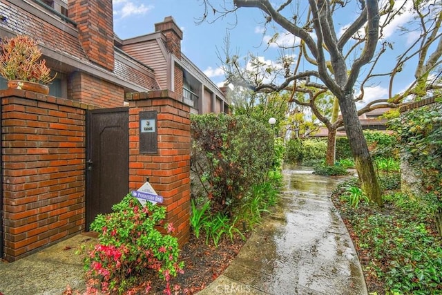 13044 Mindanao Way Unit 3, Marina Del Rey, CA 90292 - view of side of home with a gate, brick siding, fence, and a chimney
