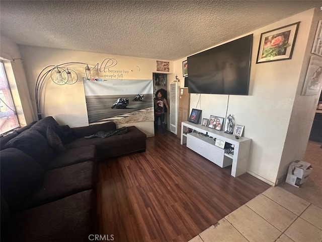 living room featuring a textured ceiling and tile patterned floors