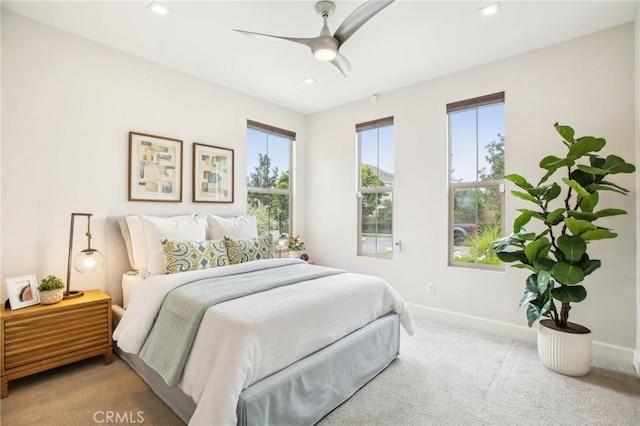 carpeted bedroom with baseboards, ceiling fan, and recessed lighting