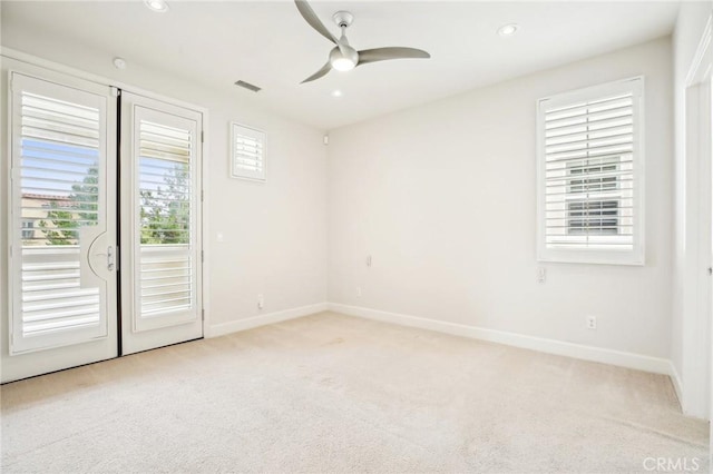 spare room featuring carpet flooring, healthy amount of natural light, baseboards, and recessed lighting