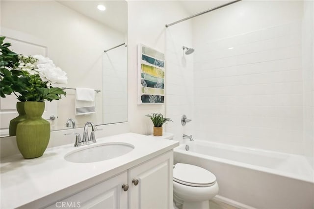 bathroom featuring toilet, vanity, and tub / shower combination