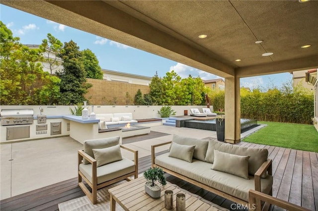 wooden deck featuring an outdoor living space with a fire pit, grilling area, area for grilling, and a fenced backyard