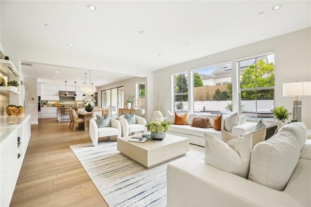 living area featuring recessed lighting and light wood-style flooring