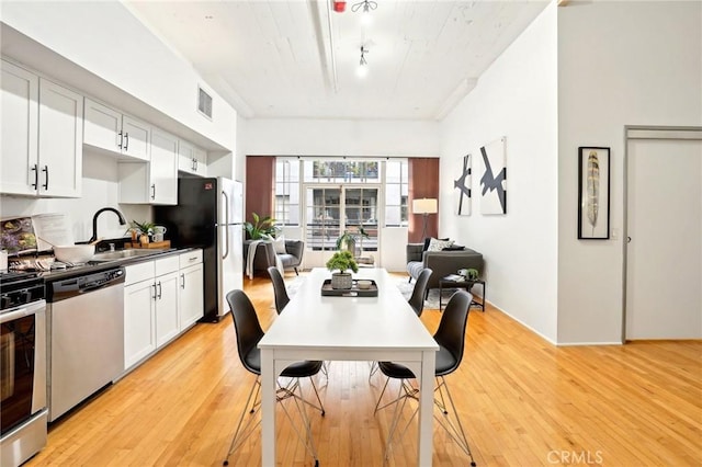 dining space featuring light wood finished floors