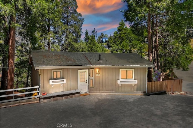 770 Berne Dr, Crestline, CA 92325 - view of front facade featuring fence, a shingled roof, and board and batten siding
