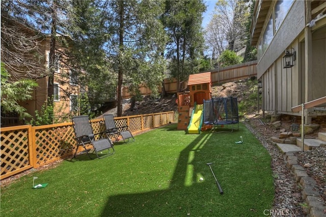 770 Berne Dr, Crestline, CA 92325 - view of yard featuring a trampoline and a playground