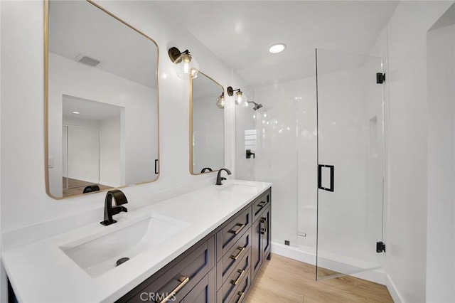 212 La Paloma, San Clemente, CA 92672 - bathroom featuring a stall shower, wood finished floors, and double vanity