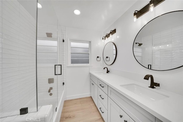 212 La Paloma, San Clemente, CA 92672 - bathroom featuring shower / bath combination with glass door, double vanity, wood finished floors, recessed lighting, and baseboards