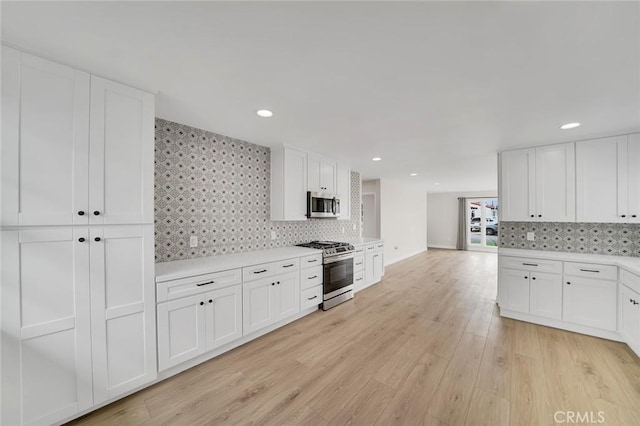 212 La Paloma, San Clemente, CA 92672 - kitchen with stainless steel appliances, light countertops, tasteful backsplash, white cabinets, and recessed lighting