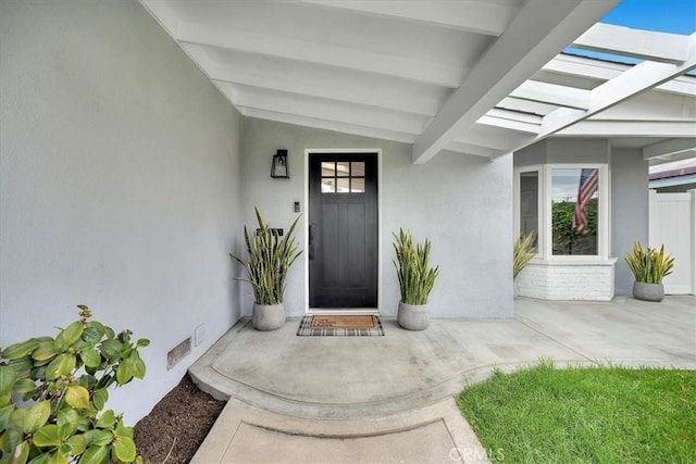 doorway to property with stucco siding