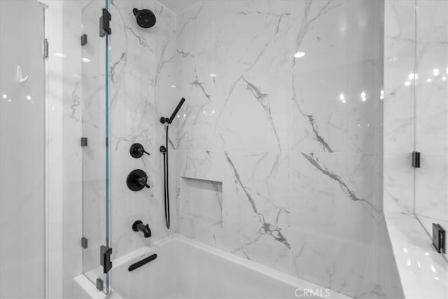 bathroom featuring combined bath / shower with glass door