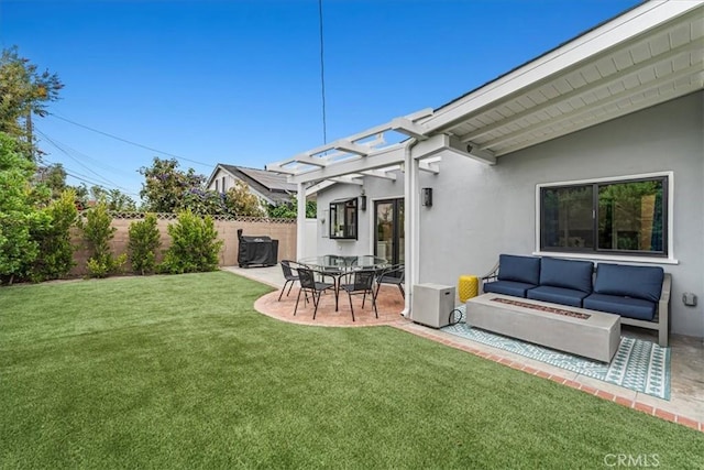 view of yard with an outdoor living space with a fire pit and a patio