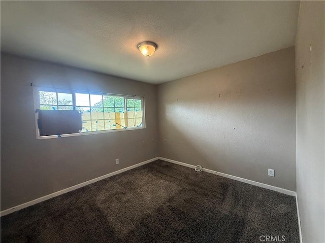 carpeted spare room with baseboards