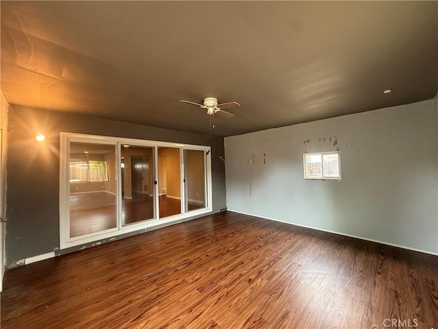 spare room with wood finished floors, ceiling fan, healthy amount of natural light, and baseboards