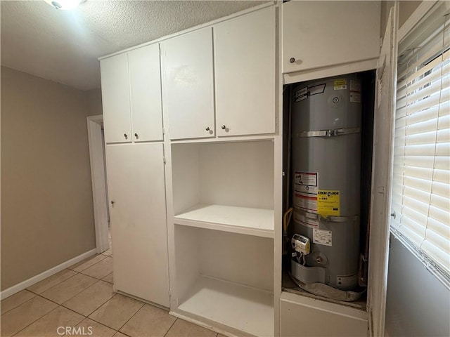 utility room featuring strapped water heater