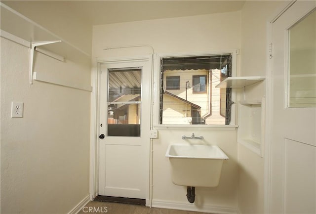 bathroom featuring a sink and baseboards