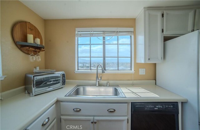 539 Elk Ridge Way, San Jose, CA 95136 - kitchen with dishwasher, a sink, white cabinetry, light countertops, and freestanding refrigerator