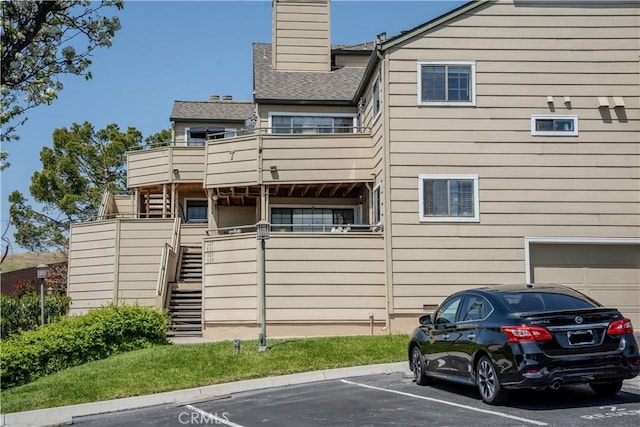 539 Elk Ridge Way, San Jose, CA 95136 - rear view of property featuring stairs, a chimney, uncovered parking, and a balcony