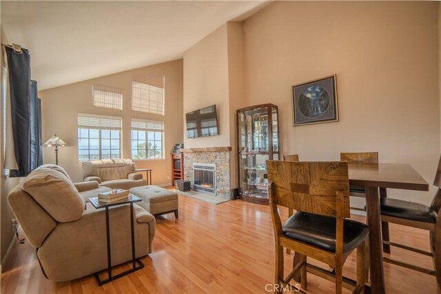 539 Elk Ridge Way, San Jose, CA 95136 - living room with high vaulted ceiling, light wood-style floors, and a stone fireplace