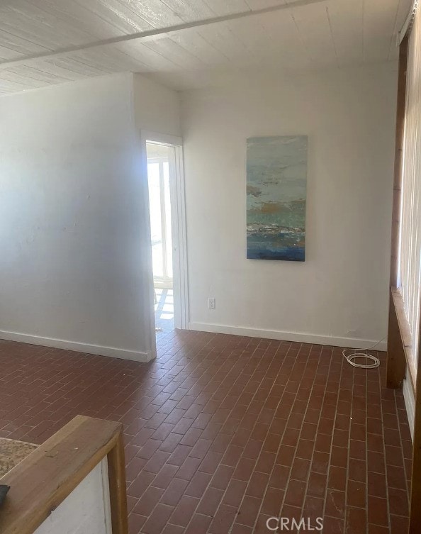 66229 8th St, Desert Hot Springs, CA 92240 - unfurnished room featuring brick flooring and baseboards