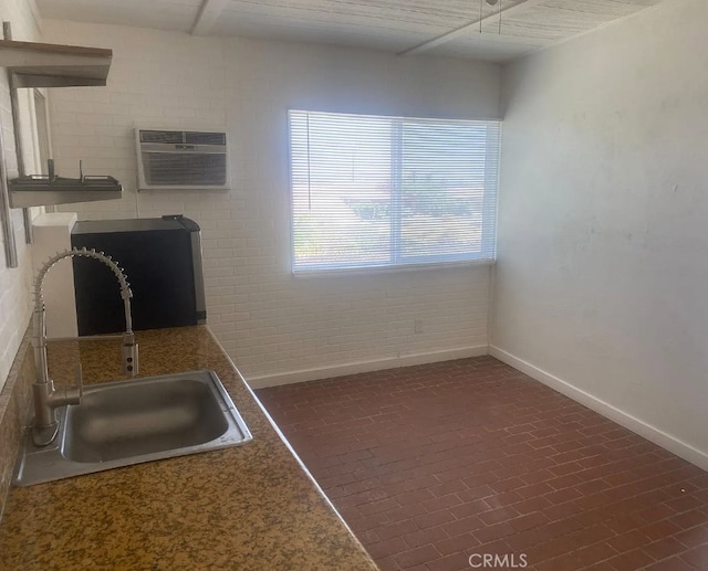 66229 8th St, Desert Hot Springs, CA 92240 - kitchen featuring a sink, baseboards, a wall unit AC, and brick patterned flooring