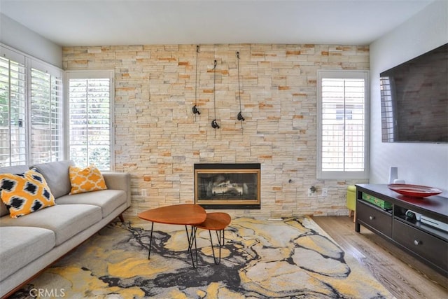 1398 Carissa St, Upland, CA 91784 - living area with wood finished floors, plenty of natural light, and a stone fireplace