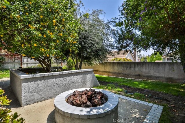 1398 Carissa St, Upland, CA 91784 - fenced backyard with an outdoor fire pit and a patio area