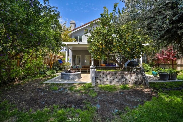 1398 Carissa St, Upland, CA 91784 - back of property featuring an outdoor fire pit, a patio area, stucco siding, and a chimney