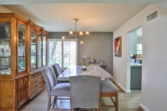 1398 Carissa St, Upland, CA 91784 - dining space featuring light wood-style floors, baseboards, and a chandelier