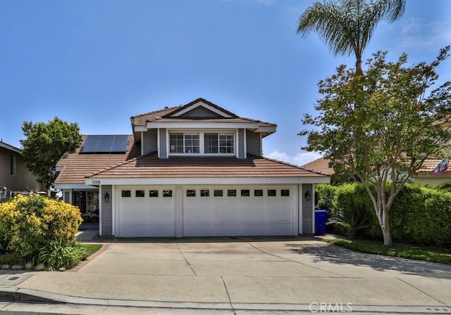 1398 Carissa St, Upland, CA 91784 - traditional-style home with a tile roof, concrete driveway, solar panels, and an attached garage