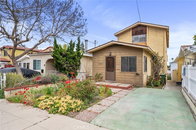 view of front of property featuring fence and stucco siding