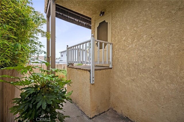 view of home's exterior featuring stucco siding and fence
