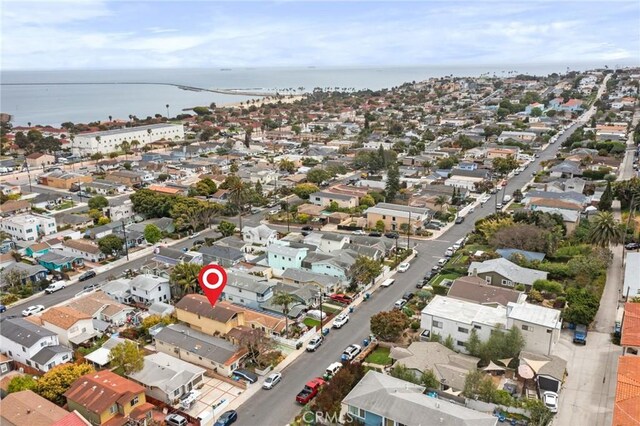 aerial view of property and surrounding area with a nearby body of water and nearby suburban area