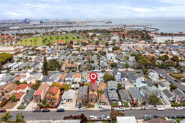 aerial view of property's location with a large body of water and nearby suburban area