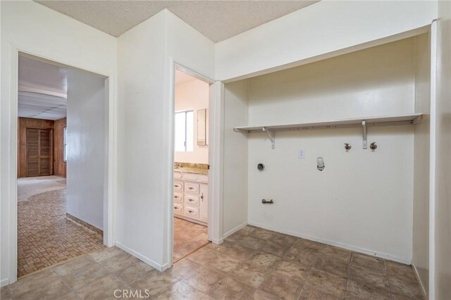 washroom featuring gas dryer hookup, electric dryer hookup, hookup for a washing machine, and baseboards