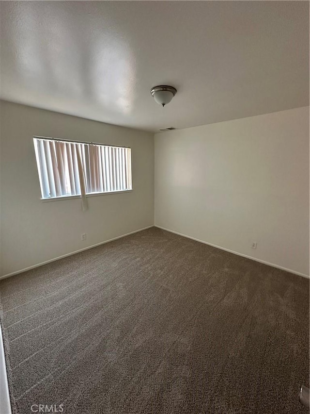 44226 2nd St E, Lancaster, CA 93535 - empty room with dark colored carpet and baseboards