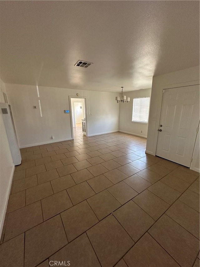 44226 2nd St E, Lancaster, CA 93535 - unfurnished room featuring a chandelier, tile patterned floors, baseboards, and a textured ceiling