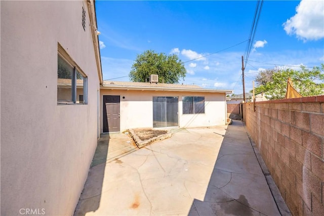 44226 2nd St E, Lancaster, CA 93535 - back of house with stucco siding, a fenced backyard, and a patio area