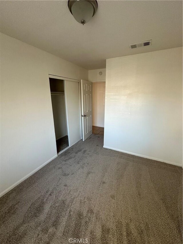 44226 2nd St E, Lancaster, CA 93535 - unfurnished bedroom with carpet, a closet, and baseboards