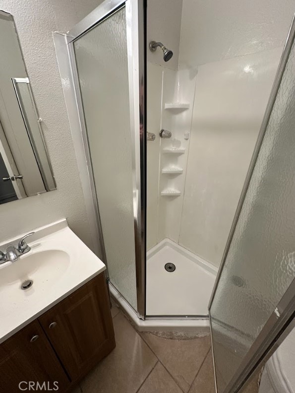 44226 2nd St E, Lancaster, CA 93535 - bathroom featuring a stall shower, tile patterned floors, and vanity
