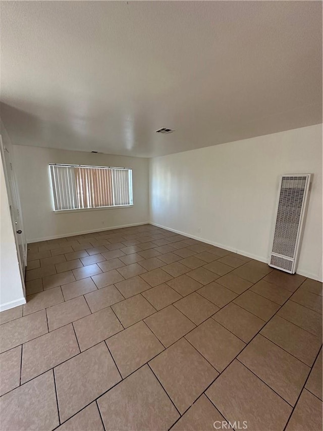 44226 2nd St E, Lancaster, CA 93535 - empty room featuring a heating unit, tile patterned floors, and baseboards