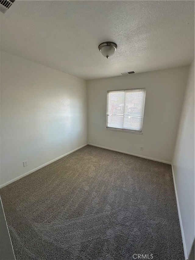 44226 2nd St E, Lancaster, CA 93535 - carpeted empty room featuring baseboards and a textured ceiling