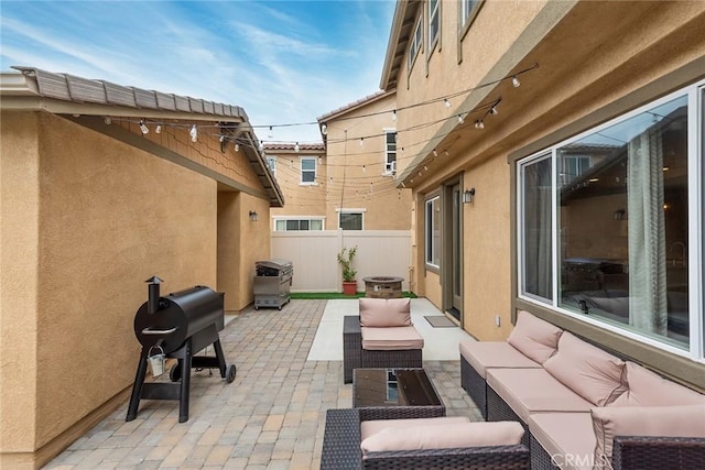 view of patio / terrace with an outdoor living space and fence