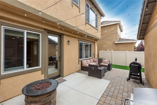 view of patio featuring fence and an outdoor living space with a fire pit