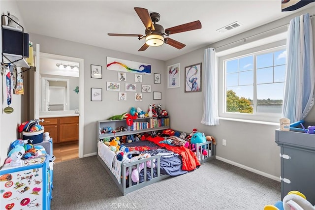bedroom with light carpet, baseboards, connected bathroom, and ceiling fan