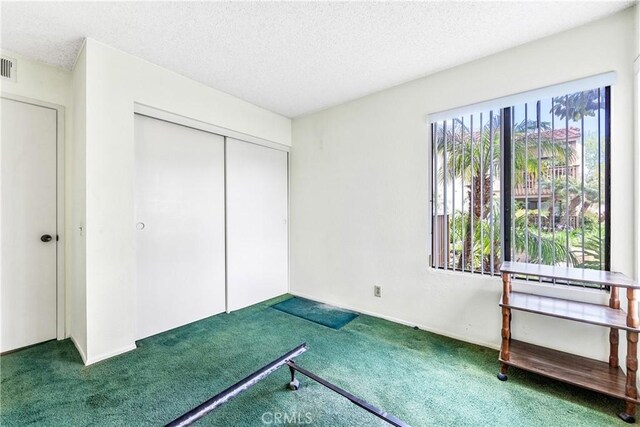 16512 Blackbeard Ln Unit 102, Huntington Beach, CA 92649 - unfurnished bedroom with carpet, a textured ceiling, and a closet