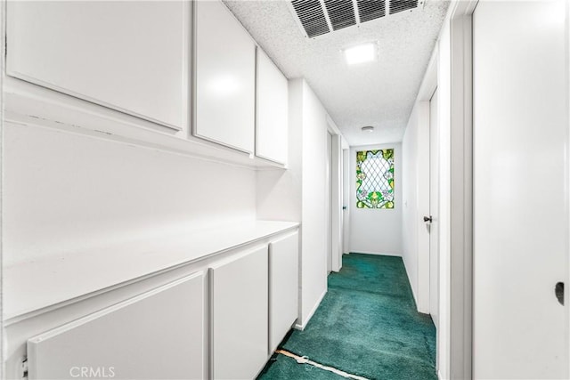 16512 Blackbeard Ln Unit 102, Huntington Beach, CA 92649 - corridor featuring dark colored carpet and a textured ceiling
