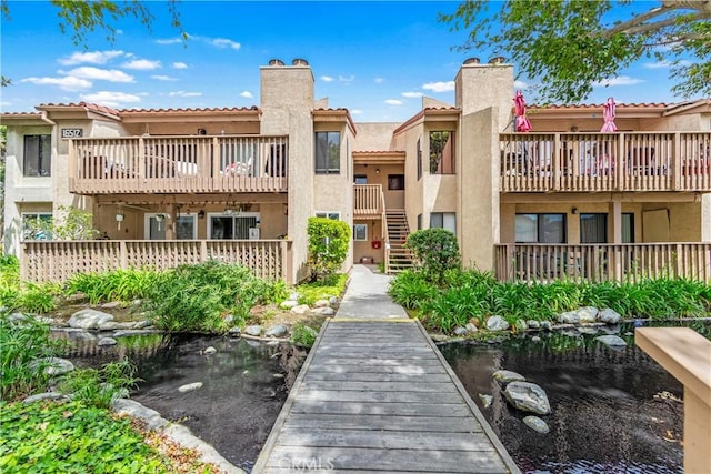 16512 Blackbeard Ln Unit 102, Huntington Beach, CA 92649 - view of building exterior featuring a small pond